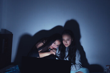 Young women at a sleepover watching very interesting and suspenseful movies.