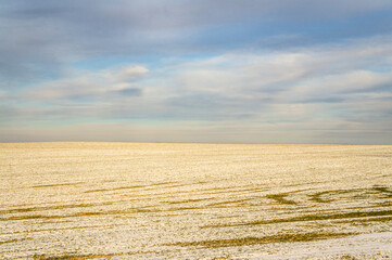 Fototapeta na wymiar Empty winter landscape with meadows and fields on a snowy day