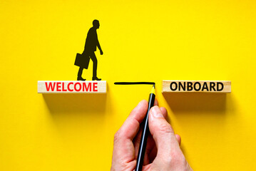 Welcome onboard symbol. Concept words Welcome onboard on wooden blocks on a beautiful yellow table...