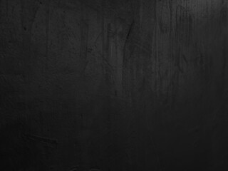 old grunge black wall texture background with blank space for design (focus at center of image). dark black cement wall texture background. metallic wall.