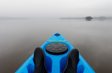 Blue kayak on open water in fog and mist at Loch Lomond
