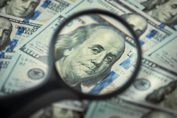 Finance and capital banking concept, Portrait of Franklin in a magnifying glass, One hundred dollar...