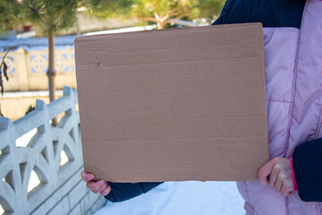 Hand holding blank cardboard box with copy space.