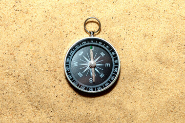 Compass on the sand at the beach