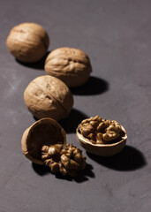 Walnuts on a dark background. The walnut is split. The core of a walnut.