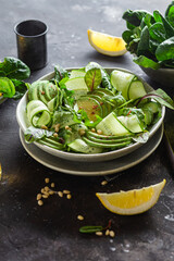 Vegetarian salad with avocado, cucumber and herbs