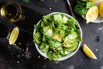 Vegetarian salad with avocado, cucumber and herbs