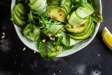Vegetarian salad with avocado, cucumber and herbs