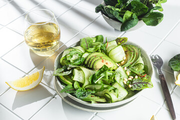 Vegetarian salad with avocado, cucumber and herbs