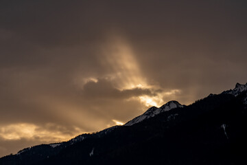 beautiful sunrise with a golden sky and mountain silhouette