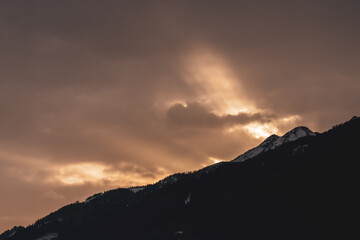 beautiful sunrise with a golden sky and mountain silhouette