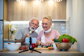 Senior couple recording video about vegetarian food