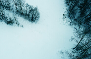 Top view of a winter empty landscape with fields and forests