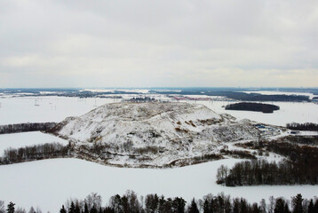 Top view of a winter empty landscape with fields and forests