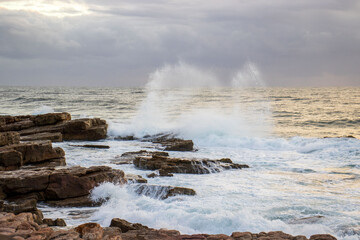 Waves crashing onto rocks on the south coast of South Africa