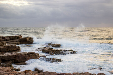 Waves crashing onto rocks on the south coast of South Africa