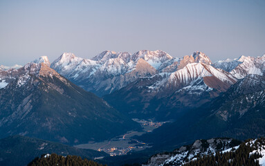 Wild mountain landscape at dusk. Snow covered rocky mountains with the Zugspitze. Tirol, Austria,...