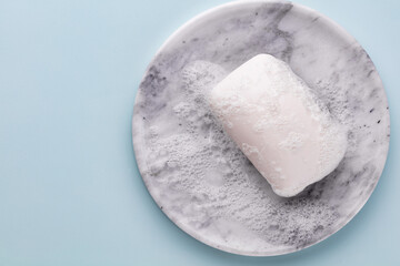 Soap bar and foam on white background, top view. Mockup for design