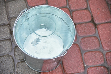 Metal bucket of water during the day