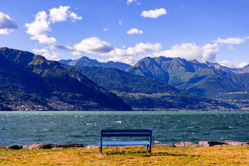 Take a break on a bench with view on the mountains of Lago di Como Italy