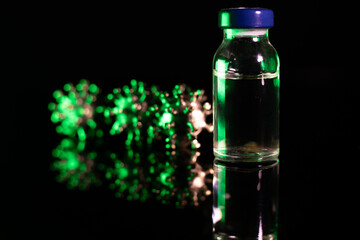 Glass jars with antibodies. A powerful angry virus with a face. The coronavirus is slightly blurred.