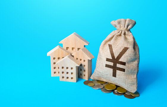 Houses And Chinese Yuan Or Japanese Yen Money Bag. Real Estate Investment And Rental Business. Increasing Property Value. Home Taxation. Residential Or Commercial Property Income. Municipal Budget.