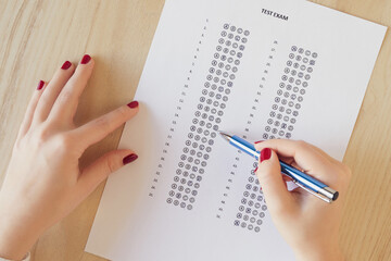 Close up and cropped examination test sheet for school / university writing answer sheets or standardized test form with answers bubbled on the table. multiple choice answer sheet. Flat lay