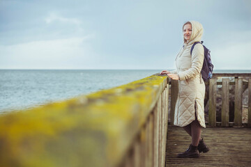 Woman standing on a pier in winter Denmark