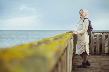 Fototapeta premium Woman standing on a pier in winter Denmark