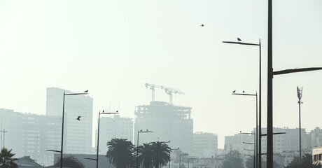 silhouettes of buildings in a bright day with haze