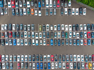 Shooting from a drone. Lots of cars in the paved parking lot. Travel, tourism, ecology, environmental protection, social issues, map, planning.