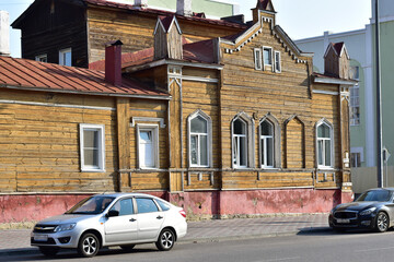 Fototapeta na wymiar City street and old wooden house.