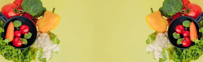 Frying pan with fresh, bright colorful vegetables on a yellow background. Panorama with copy space