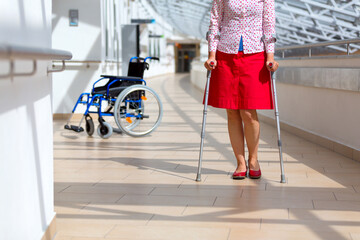 woman practicing walking on crutches - 486767377