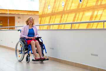 young woman on wheelchair in the medical center - 486767379