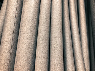white foam rubber round shape, volumetric foam rubber for construction work. goods in a hardware store for insulation and insulation of pipes. foam pipe with insulation seam