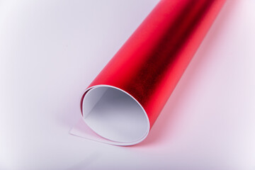 Roll of red shiny paper for creativity. Isolon for flowers.