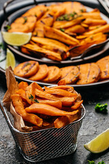 Sweet potatoes fries with lime and herbs yogurt sauce. banner, menu, recipe place for text, top view