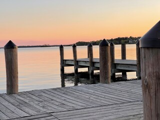 Fototapeta na wymiar Doc with yellow sunset over lake