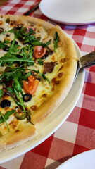 Delicious pizza with arugula and mozzarella.