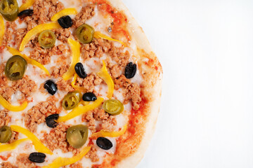 Colorful pizza with cucumbers jalapeno peppers and olives close-up.