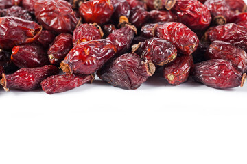 Red dry rose hips on a white background. 