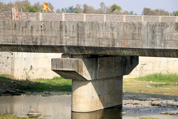 Close-up view of bridge with pillar on river