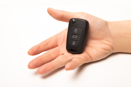 Car key in hand isolated on white background