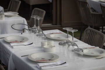 restaurant table set up with dishes outdoors