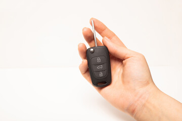 Car key in hand isolated on white background