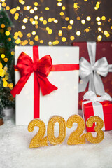 Happy new year 2023 background. New year holidays and christmas card invitation with bright lights, gifts.