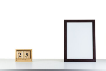 Wooden calendar 32 January with frame for photo on white table and background
