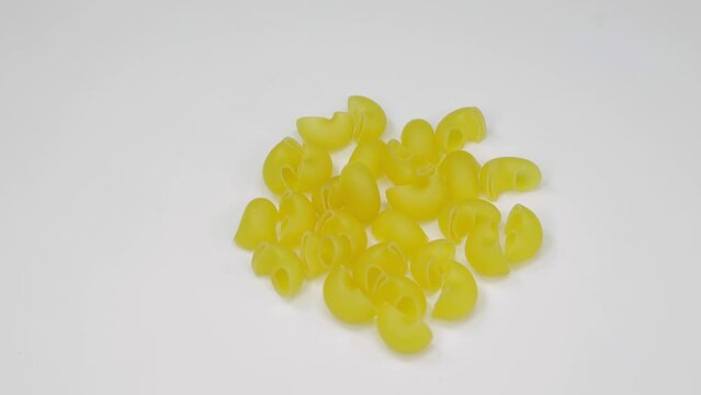 raw pasta rotates on a white background isolated