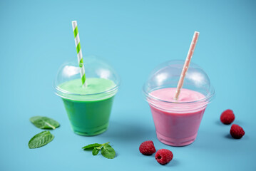 Green and red milkshake in glass